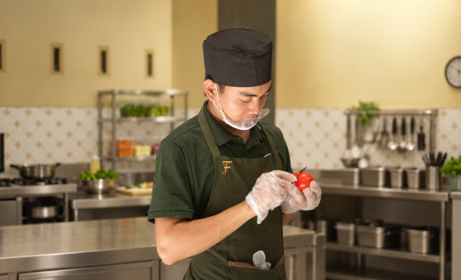 Focused Chef Preparing a Tomato Chef Trias Catering menyiapkan bahan segar di dapur